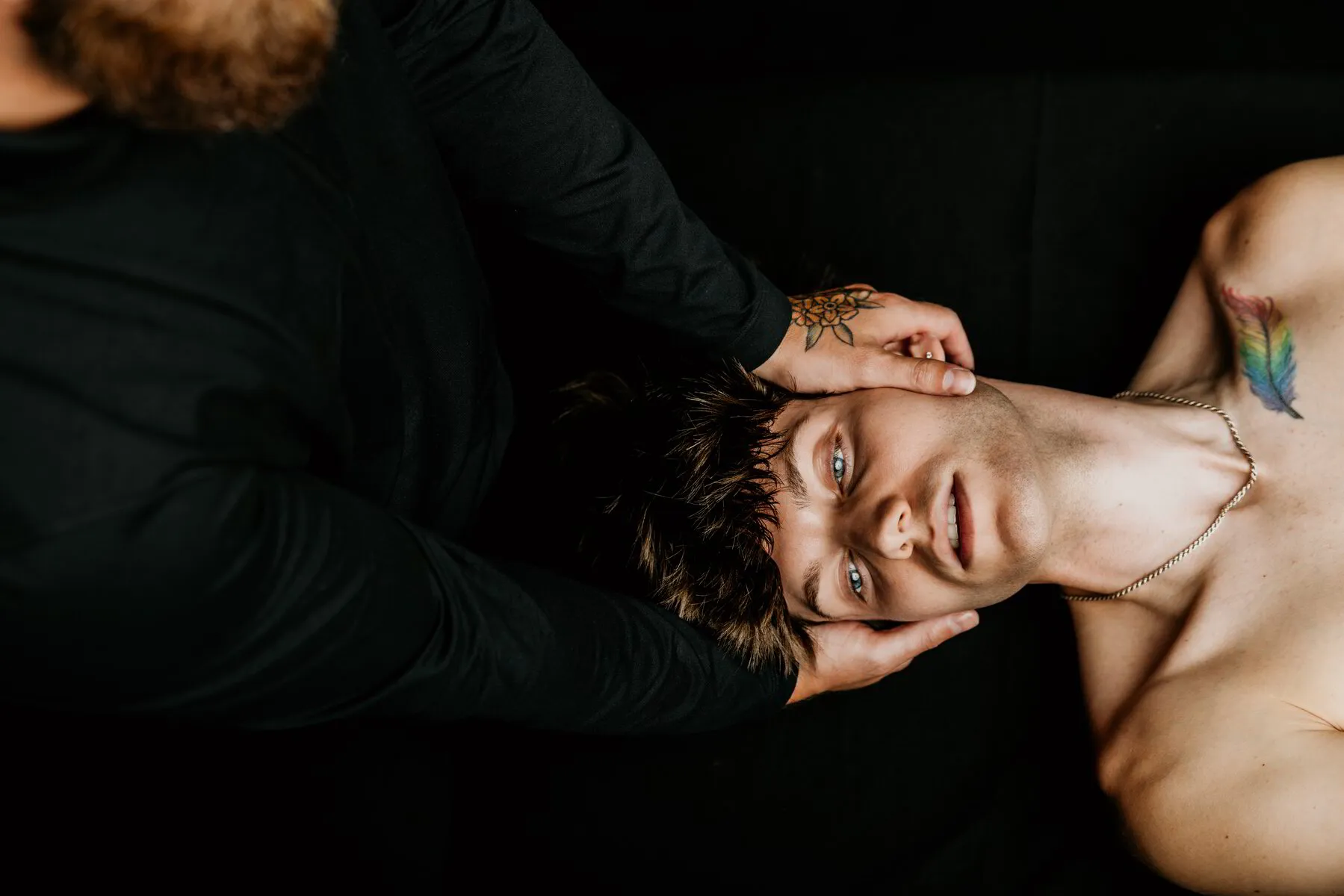 Hands gently cradling a client’s face during a facial